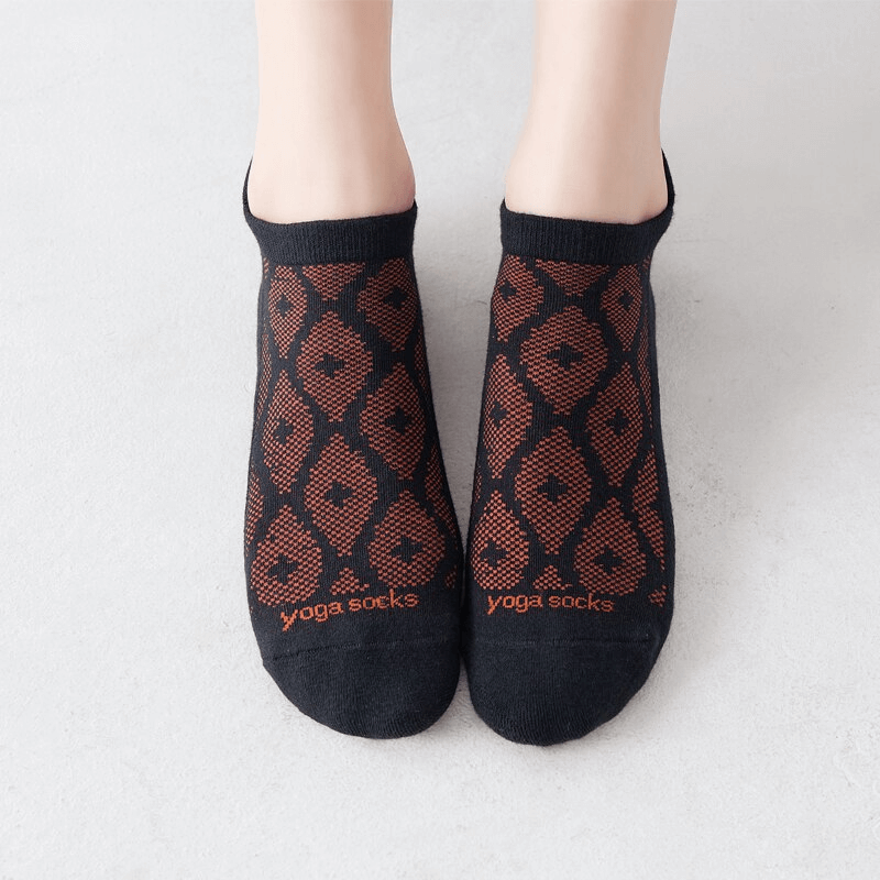 Black and orange ladies breathable anti-slip cotton Pilates socks worn, showcasing elegant design and comfort.
