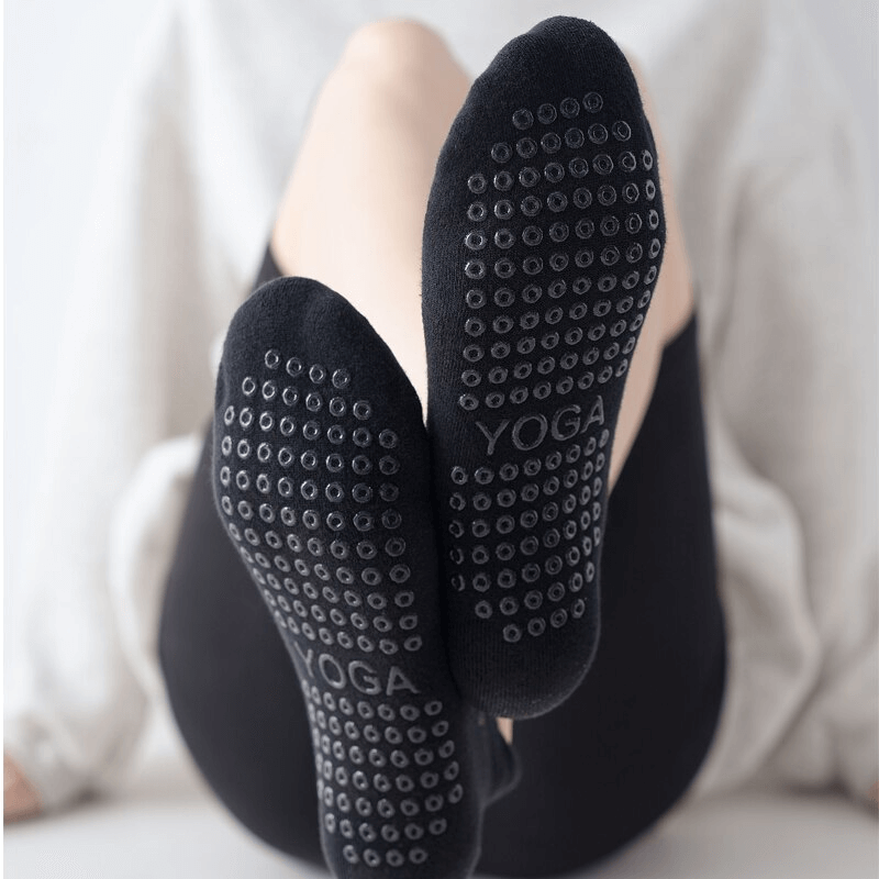Woman wearing breathable anti-slip cotton Pilates socks with grip, perfect for yoga and casual workouts, showcasing comfort and style.