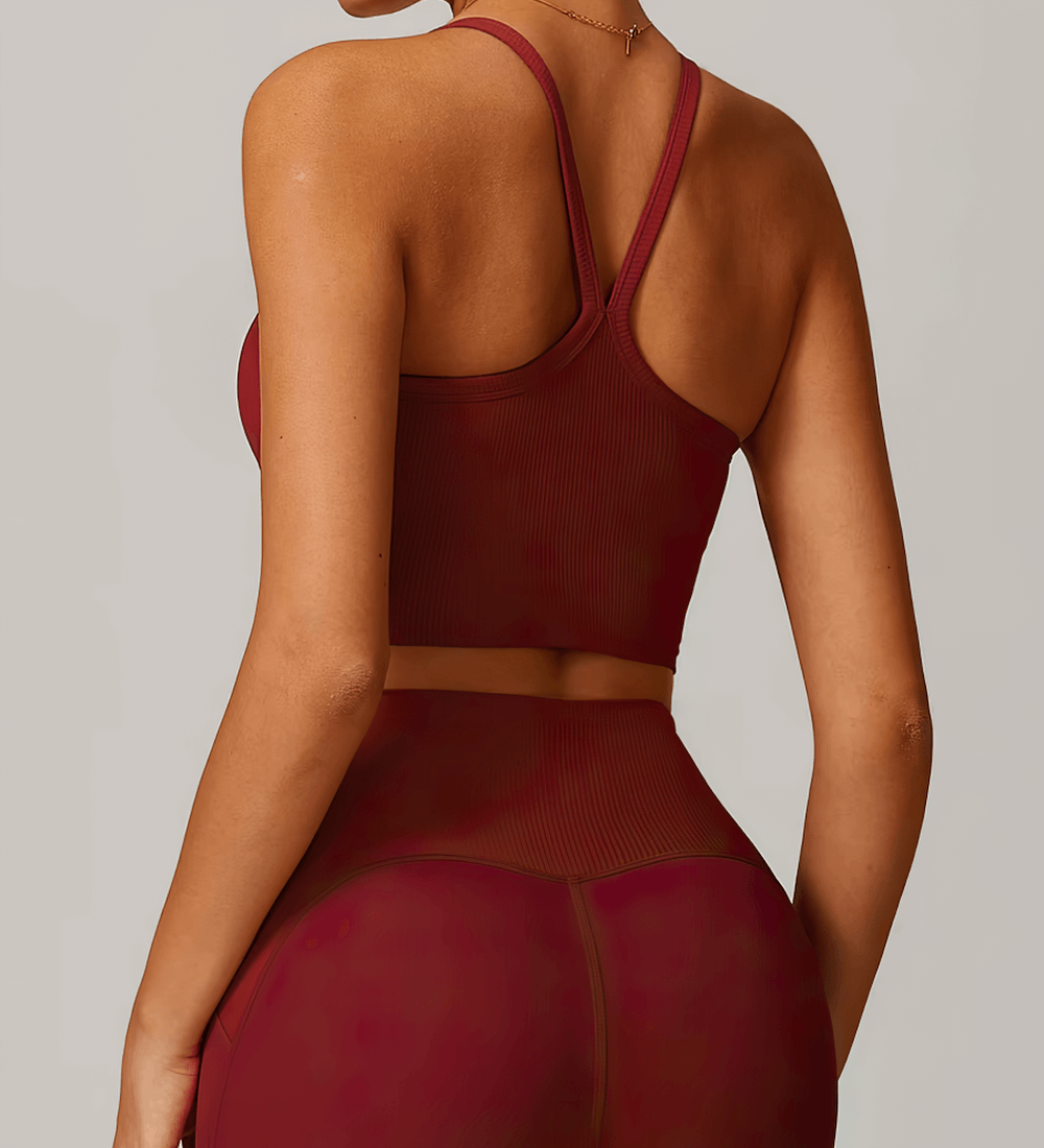 Woman wearing a stylish red ribbed racerback sports tank top, perfect for running, yoga, and workouts. SF2444 high-impact performance.