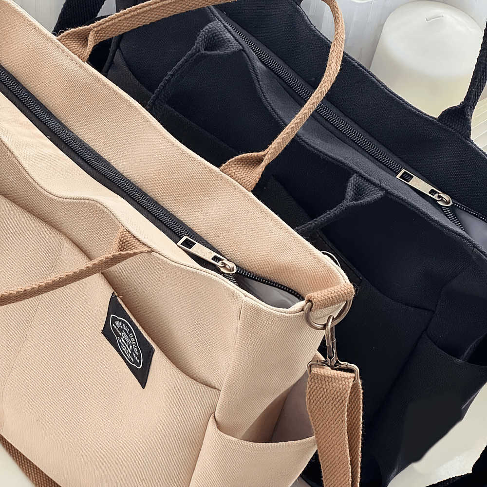 Large canvas tote bags with multi-pocket design, beige and black, featuring durable zippers and adjustable straps, perfect for daily use.