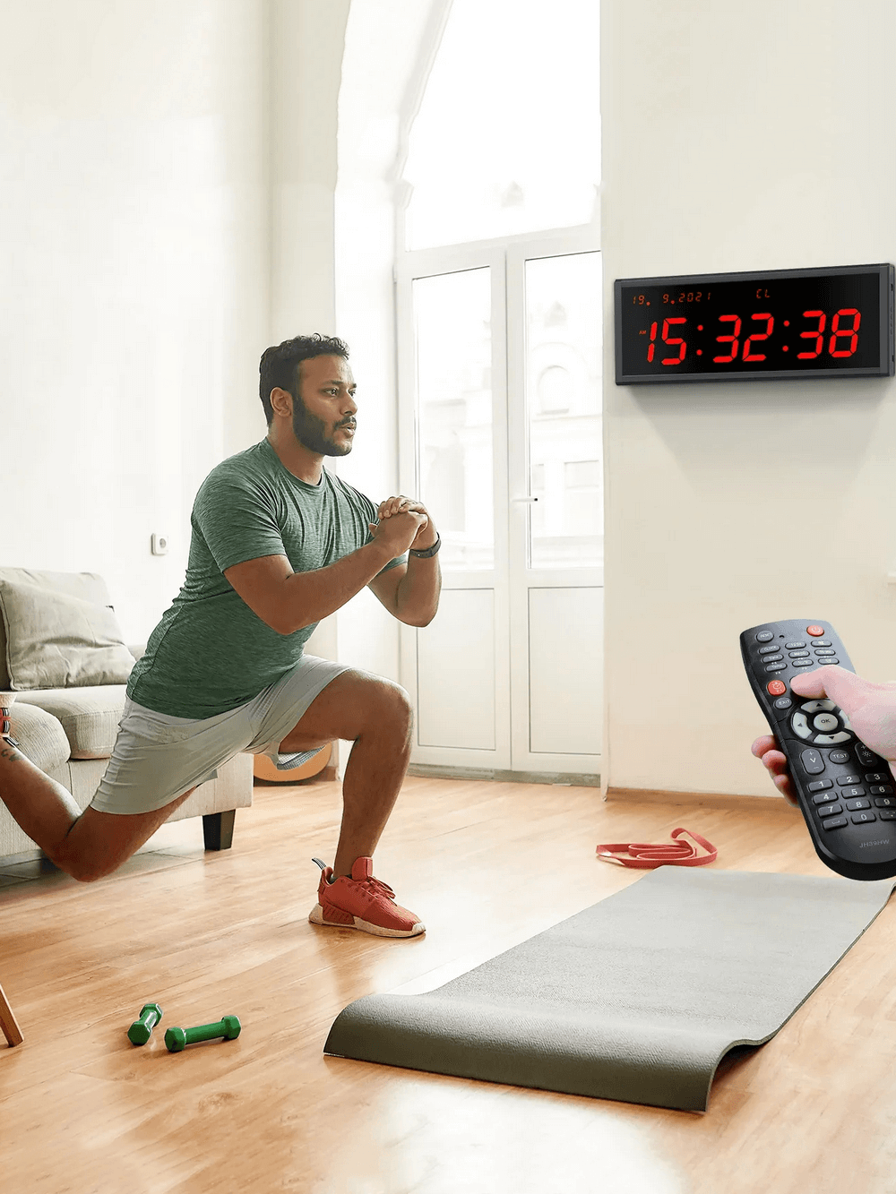 Man working out with Large LED Digital Wall Gym Timer Clock with Remote - SF3473 visible, exercising with remote control in hand.