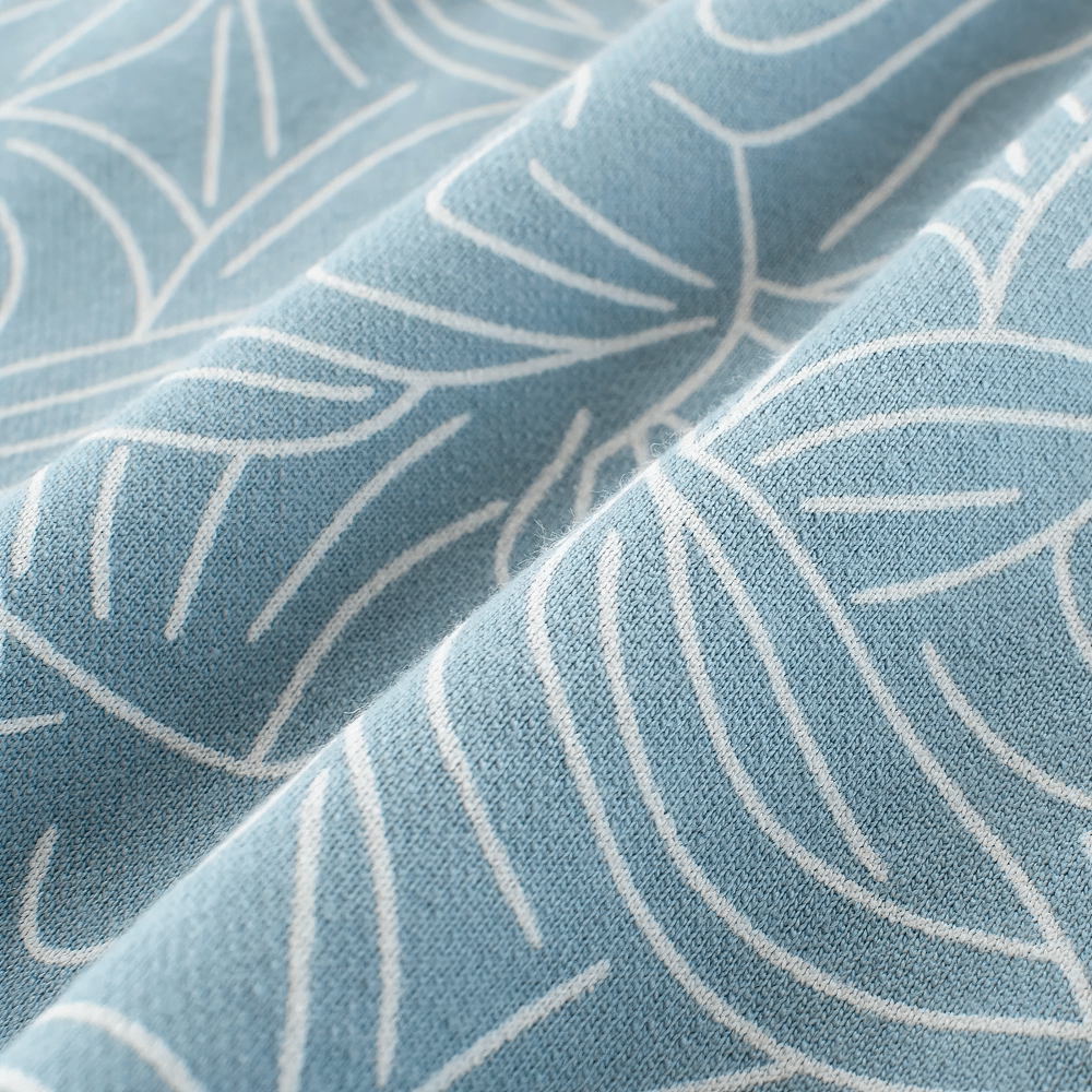 Close-up of blue fabric with white leaf pattern for Leaf Print Shorts with Elastic Waist and Pockets - SF3790