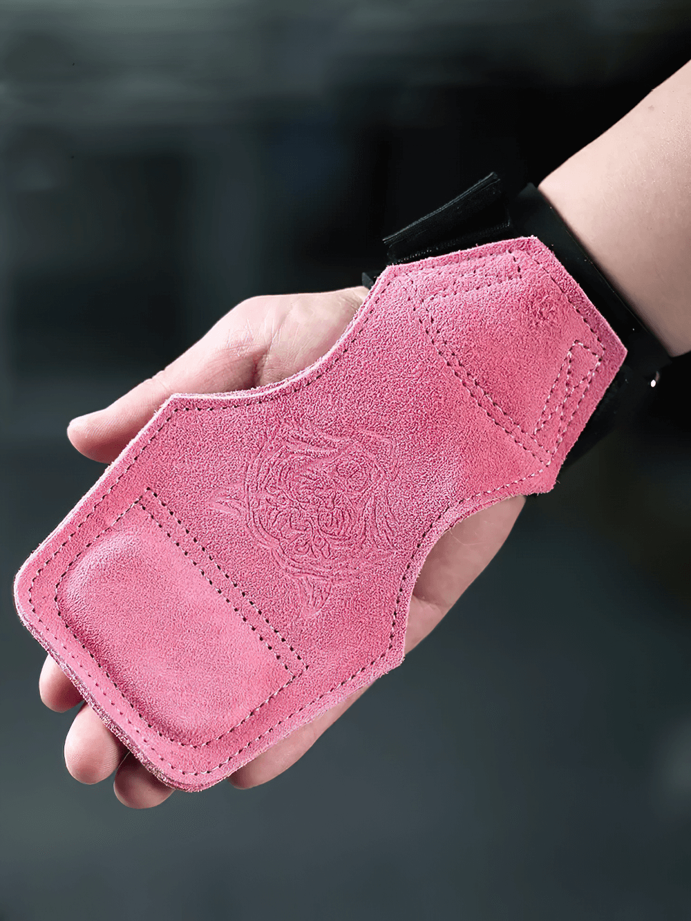 Person holding pink Leather Gym Hand Grips with Wrist Support Straps - SF3519 showcasing durable cowhide suede and comfort in training gear.