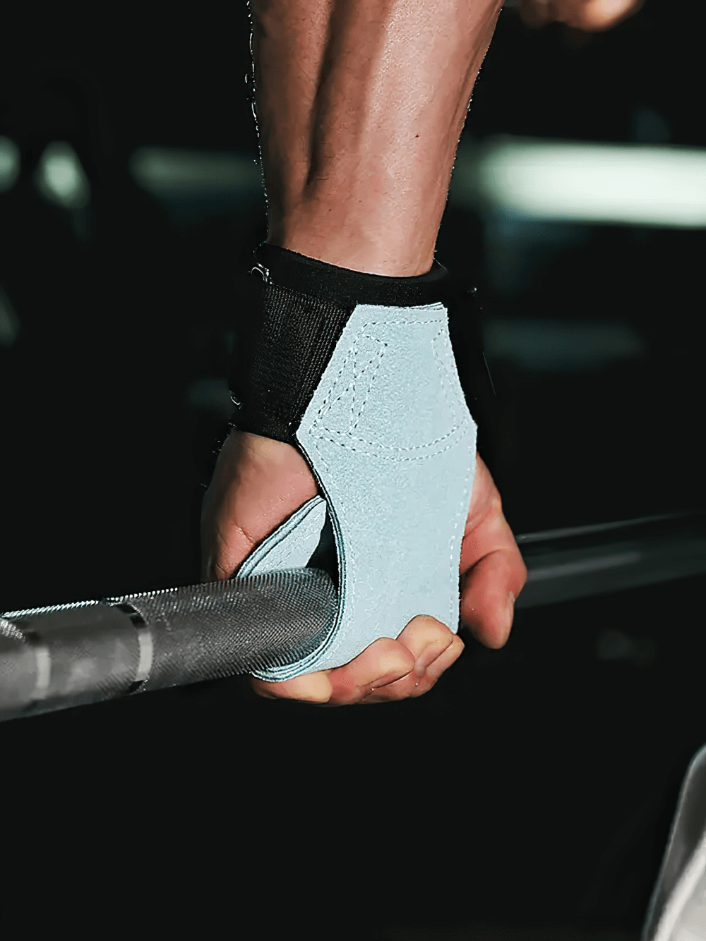 Close-up of person using Leather Gym Hand Grips with Wrist Support Straps - SF3519 for weightlifting, showing secure grip.
