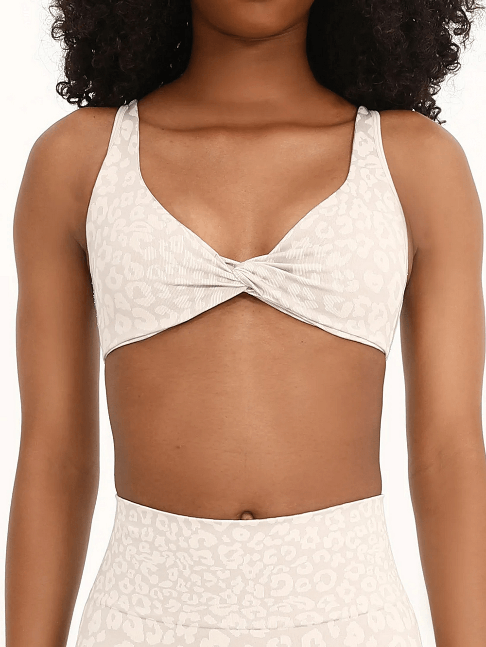 Woman wearing Leopard Print Sports Bra with Adjustable Straps - SF4086 showcasing twist design and active wear style.