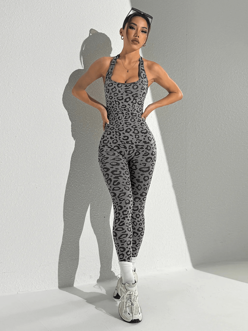 Woman wearing Leopard Print Yoga Jumpsuit with Open Back Design - SF4232, showcasing fitness style with a modern athletic look.
