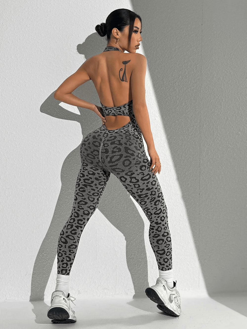 Woman in Leopard Print Yoga Jumpsuit with Open Back Design - SF4232, showcasing fitness fashion for yoga, gym, and training routines.