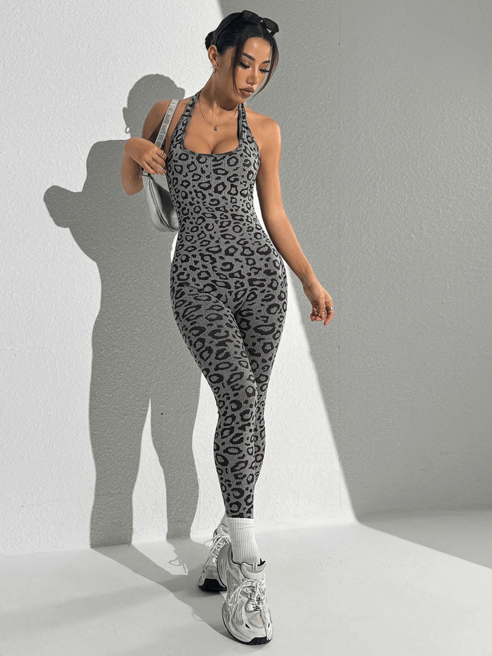 Woman wearing Leopard Print Yoga Jumpsuit with Open Back Design - SF4232, ideal for gym and yoga sessions in style.