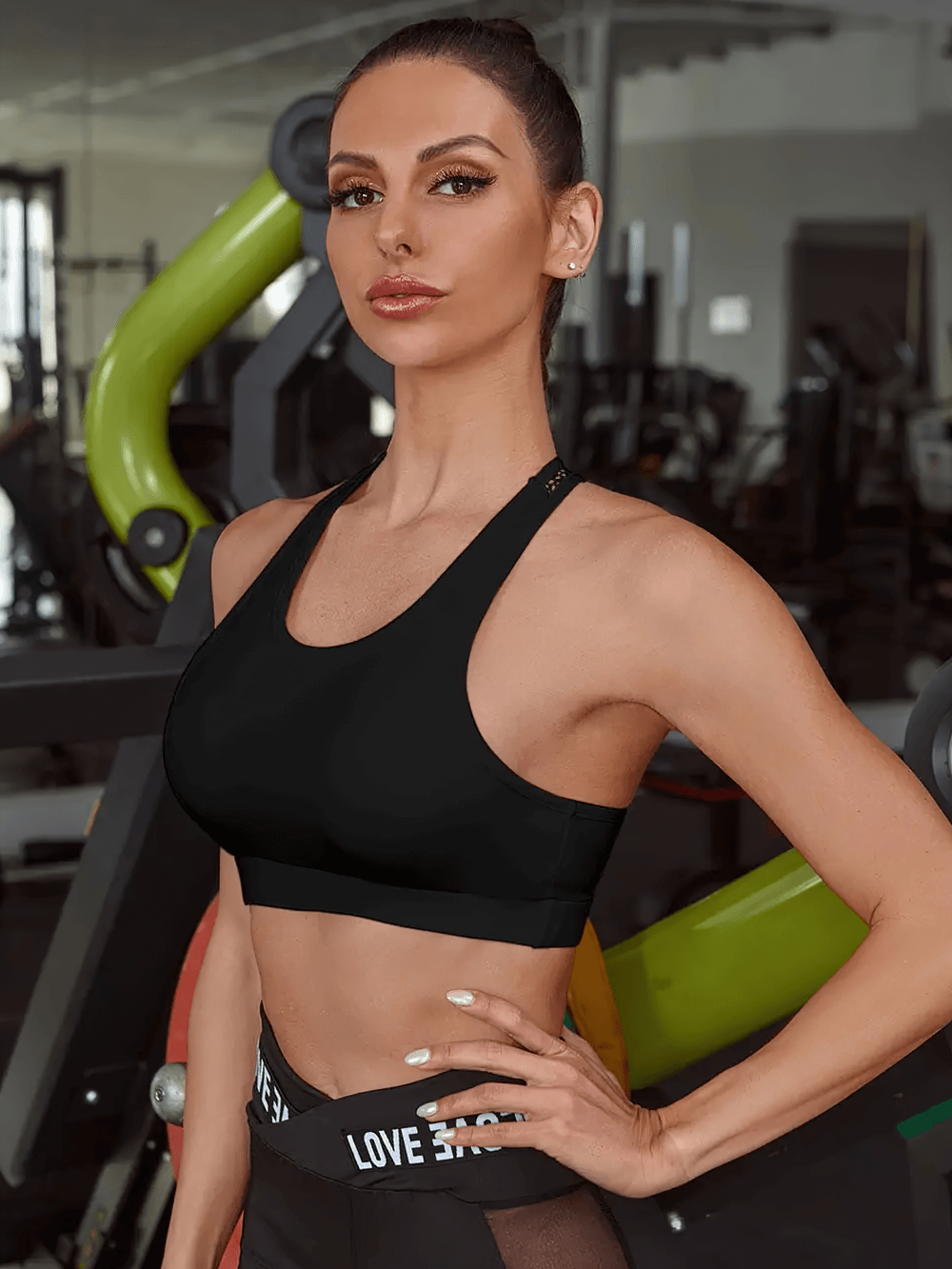 Woman wearing Letter Strap Mesh Racerback Sports Bra for Women - SF4031, perfect for fitness and yoga, with LOVE letter tape accent.