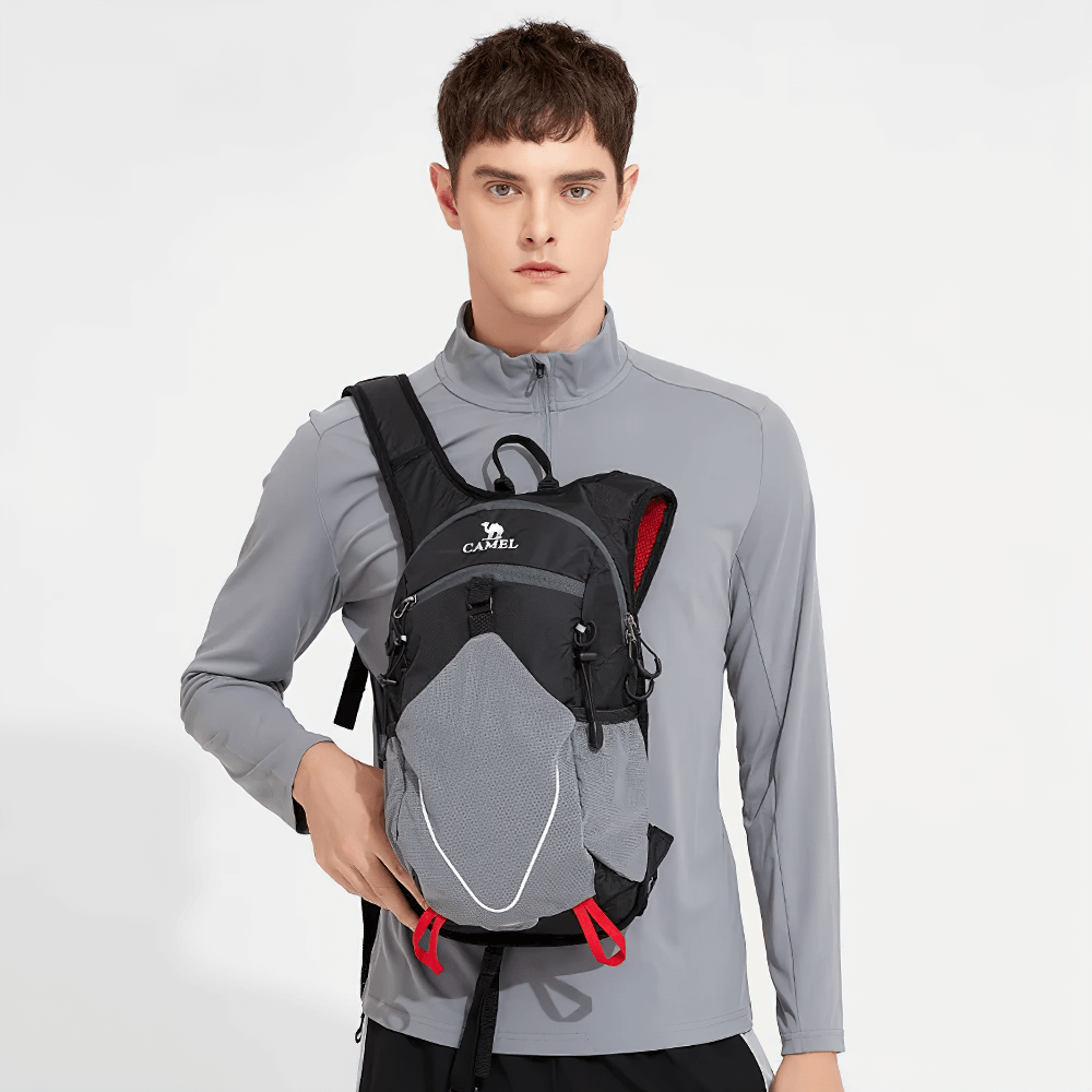 Person wearing a lightweight water-repellent 15L cycling backpack in grey, perfect for hiking, travel, and outdoor activities.