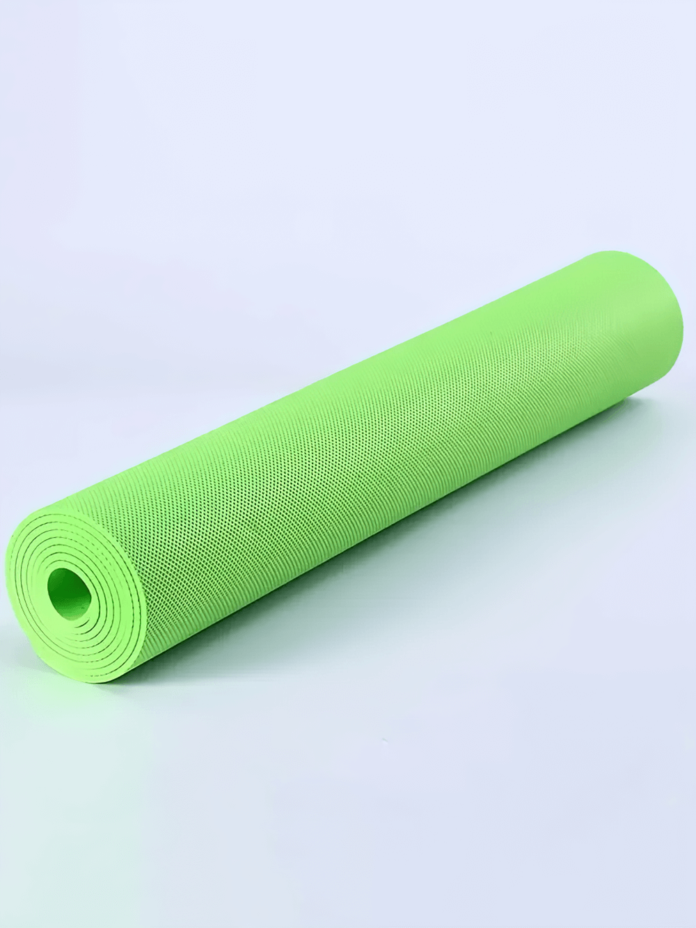Green lightweight EVA yoga mat for training, rolled up and ready for the gym. Non-slip and durable design for floor exercises.