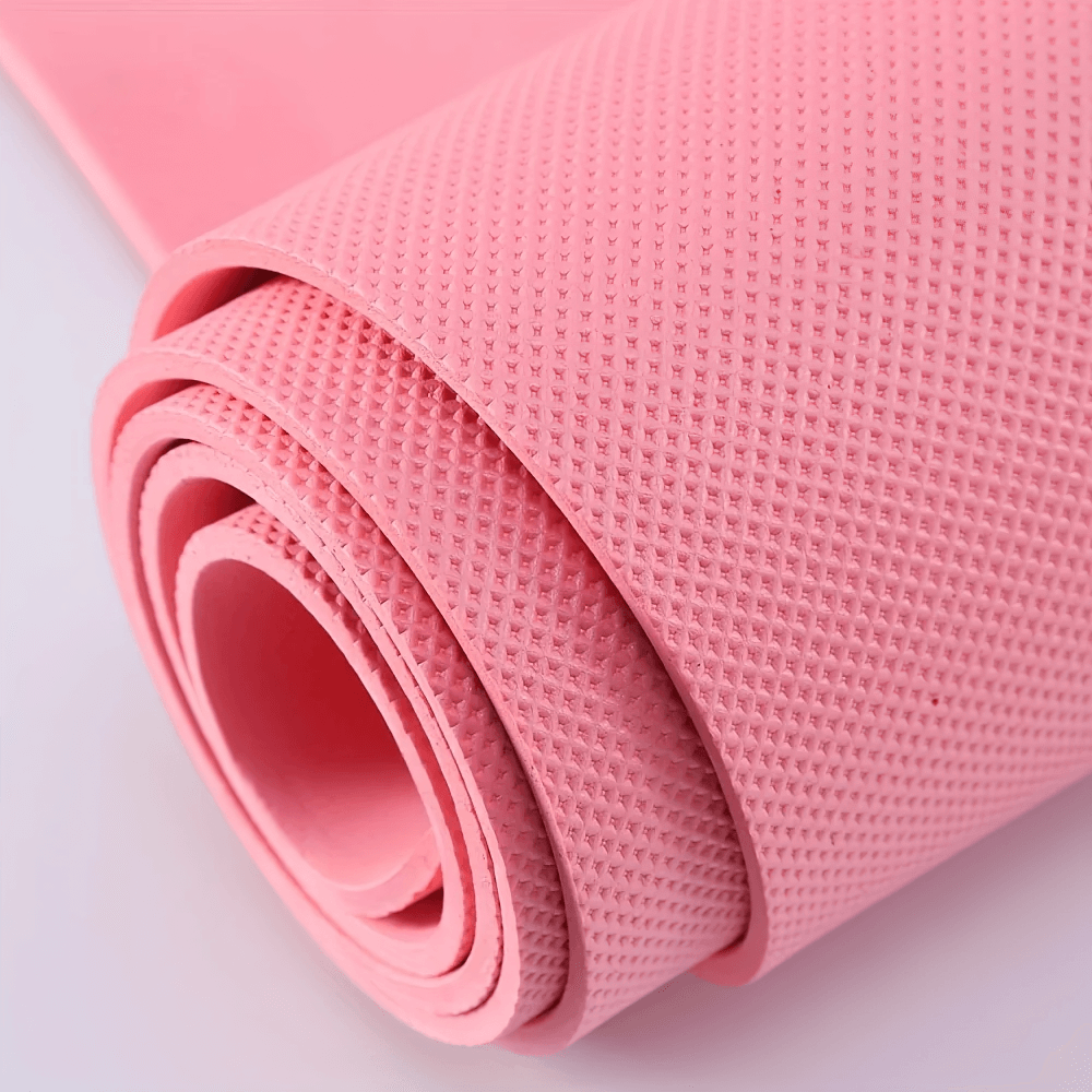 Pink lightweight anti-slip EVA yoga mat rolled up, showcasing textured non-slip surface for stable training and pilates sessions.