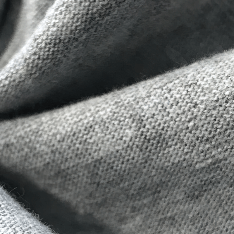 Close-up texture of lightweight breathable cotton fabric ideal for men's hoodie and sportswear, highlighting softness and durability.