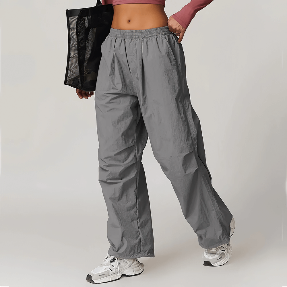 Woman wearing lightweight high-waist gray pants with pockets, perfect for yoga, hiking, or fitness. SF2359 breathable and versatile style.