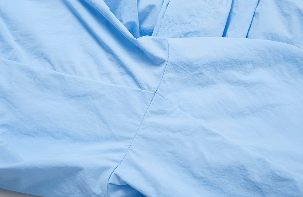 Close-up of lightweight blue nylon fabric of SF2359 women's pants, showcasing breathable and versatile material for active wear.