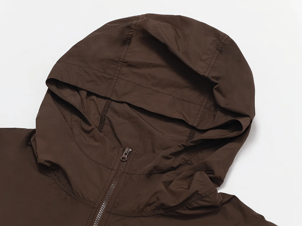 Brown lightweight hooded jacket for active women with breathable fabric and adjustable drawcord hem, perfect for outdoor activities.