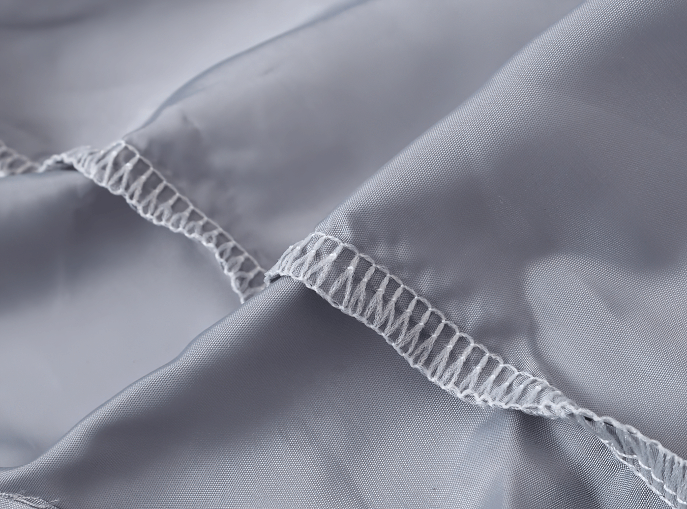 Stitching detail on Lightweight Hooded Windbreaker with Rainbow Zipper - SF3635, showcasing durable fabric for boys' fashion jacket.