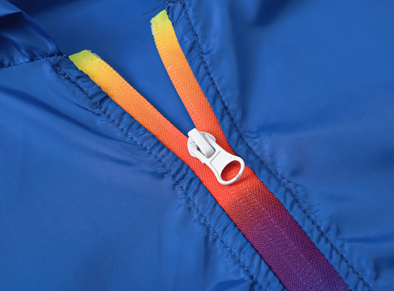 Close-up of blue Lightweight Hooded Windbreaker with Rainbow Zipper - SF3635, highlighting vibrant zipper detail for boys' fashion.