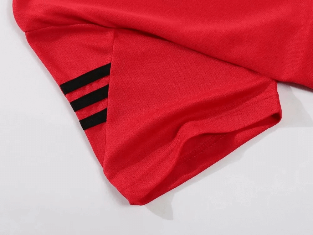 Close-up of a red athletic T-shirt with black stripe detail, part of a lightweight men's sports set ideal for running and workouts.