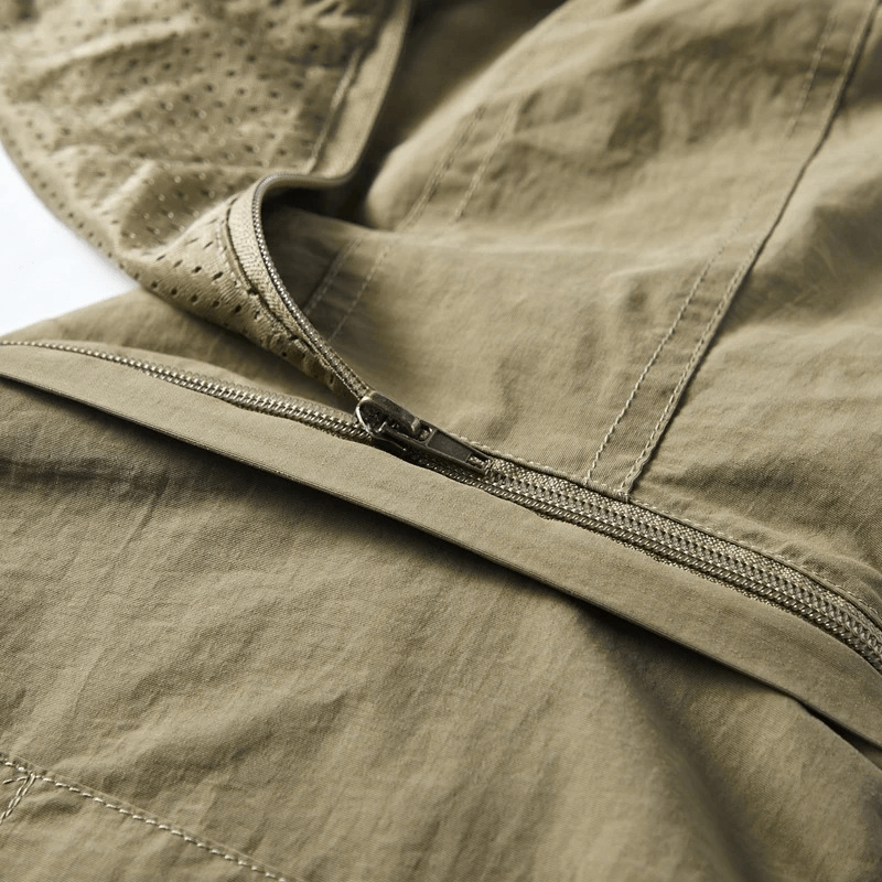 Close-up of lightweight men's vest with hood and zipper in khaki, showcasing breathable polyester fabric and stylish design.