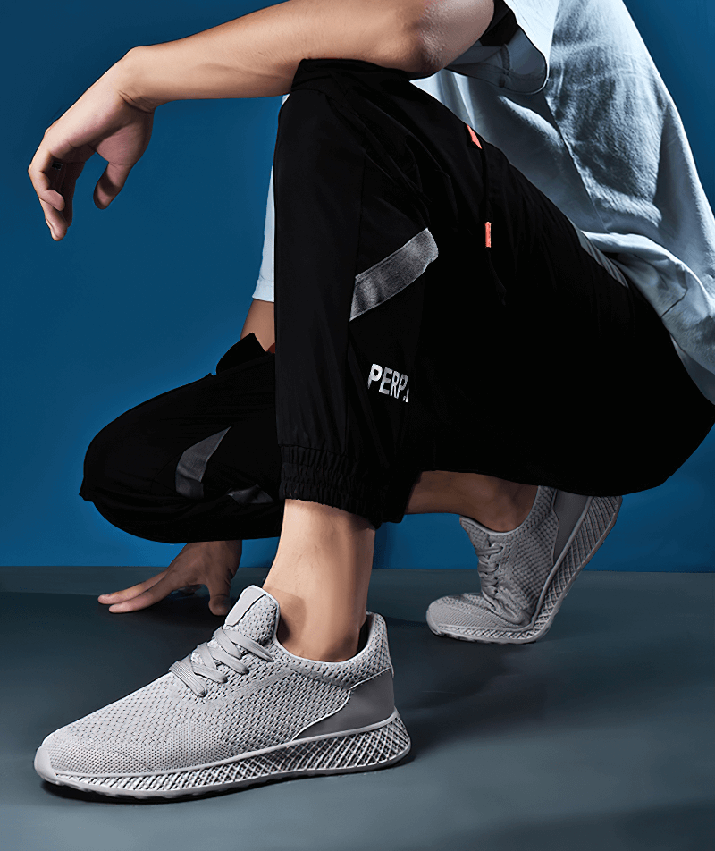 Man wearing Lightweight Mesh Tenis Shoes SF1345 for outdoor training, showcasing their breathable air mesh and EVA cushioning design.