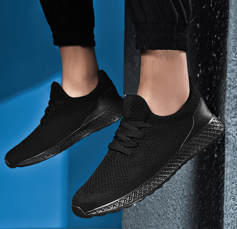 Men's black lightweight mesh tennis shoes for outdoor running, featuring air mesh upper and rubber outsole for superior traction.