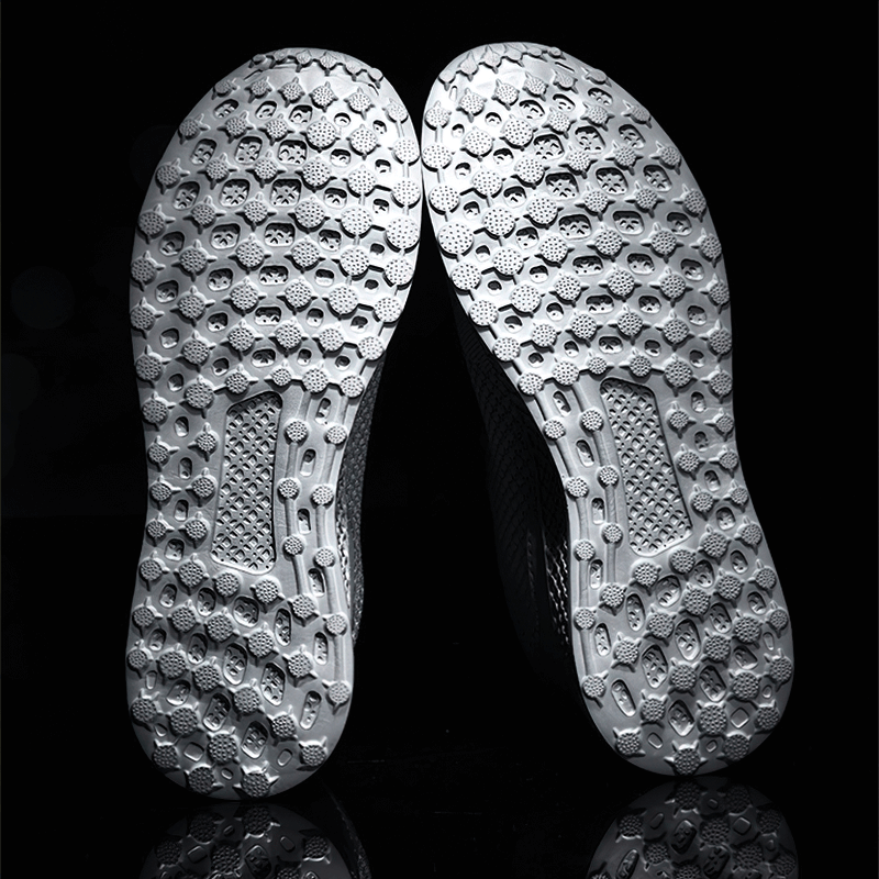 Close-up of the rubber outsole on mesh men's outdoor training shoes, showcasing textured pattern for superior traction and flexibility.