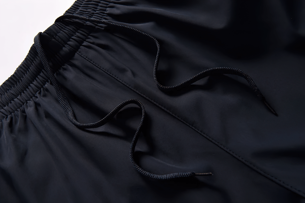 Close-up of black drawstring waistband on waterproof pants for outdoor sports SF2284. Comfortable, adjustable fit for active wear.