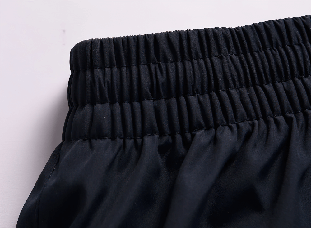 Close-up of elastic waist on lightweight sports pants, showcasing breathable, windproof, and waterproof fabric for outdoor activities.