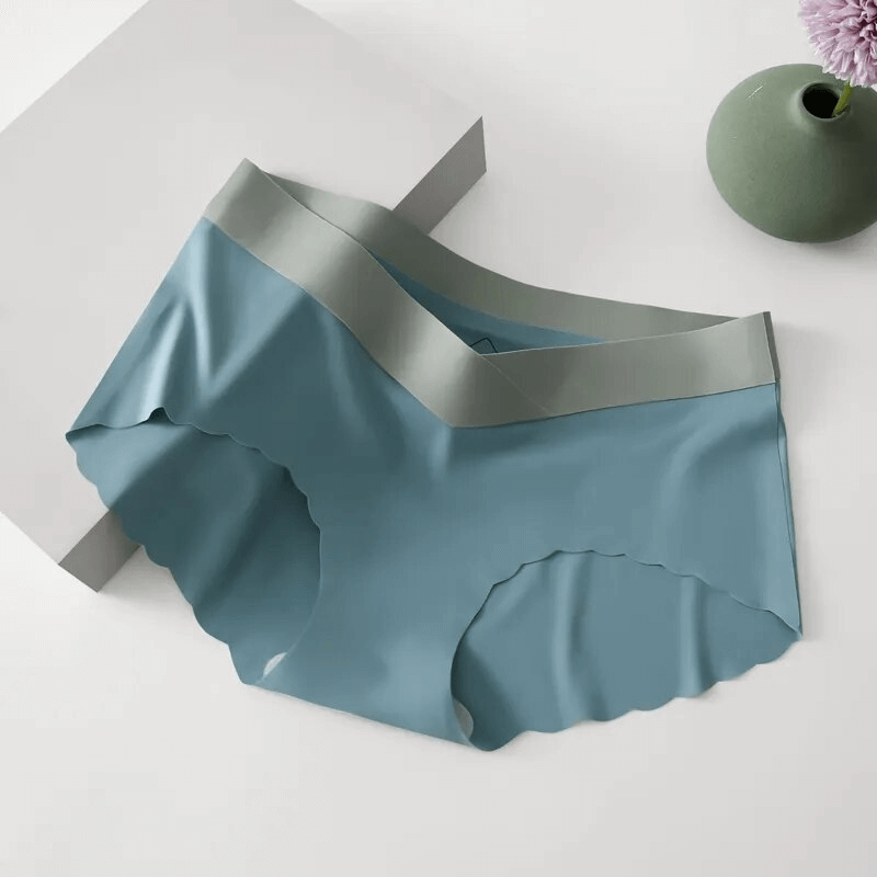 Lightweight seamless low waist panties in blue, women's breathable underwear with no decoration, displayed next to a vase.