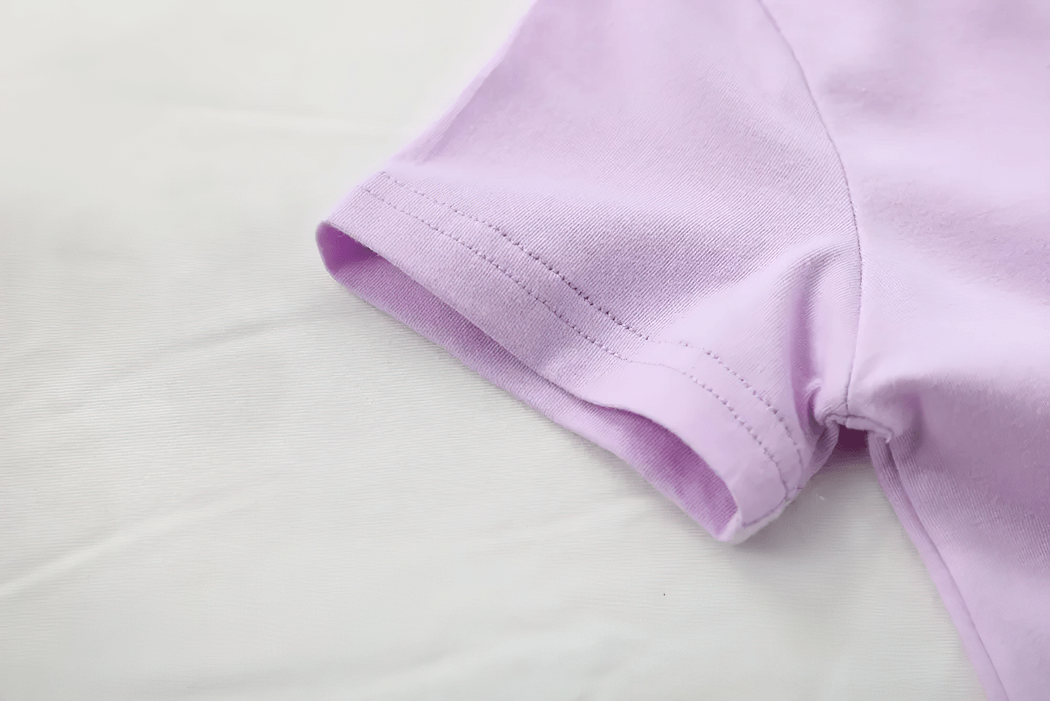 Close-up of a Lightweight Solid Color Short-Sleeve Cotton Tee - SF3851 in pastel lavender, highlighting the soft fabric and stitching detail.