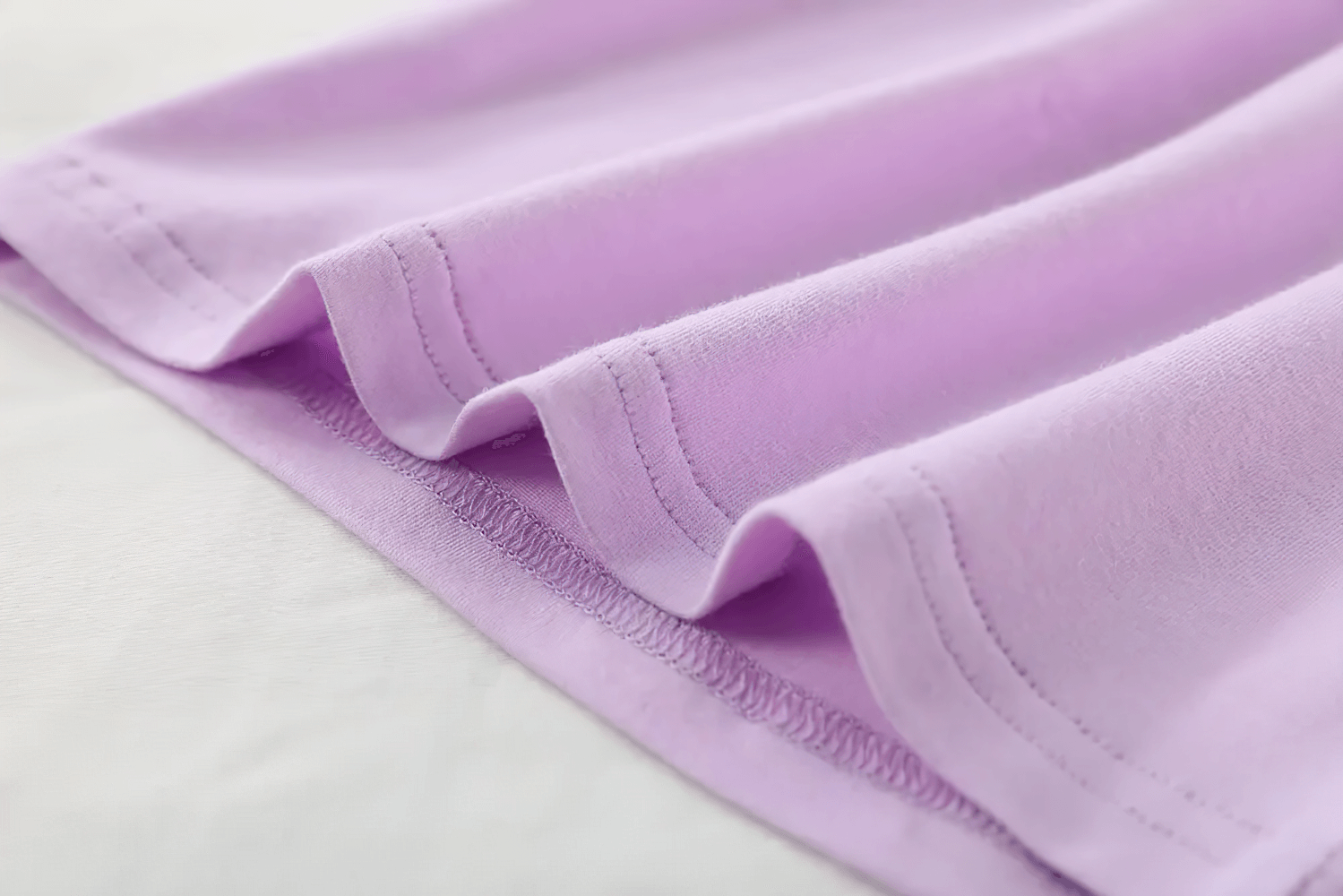 Close-up of Lightweight Solid Color Short-Sleeve Cotton Tee - SF3851 in pastel purple fabric detail