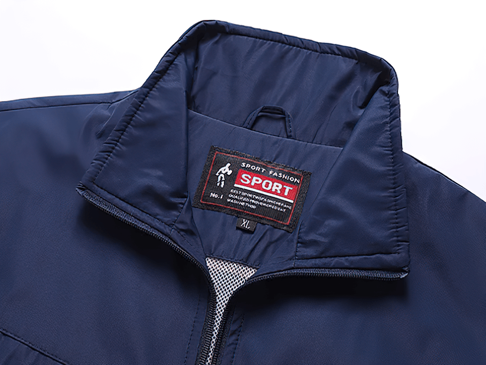 Close-up of the collar and label of a navy blue lightweight sports tracksuit jacket, showcasing breathable fabric and sporty design.