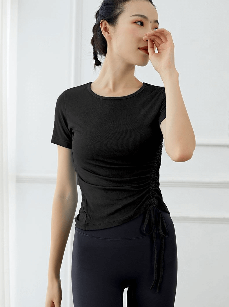 Lightweight sporty elastic women's T-shirt with side tie, perfect for yoga workouts, worn by model showcasing comfort and style.