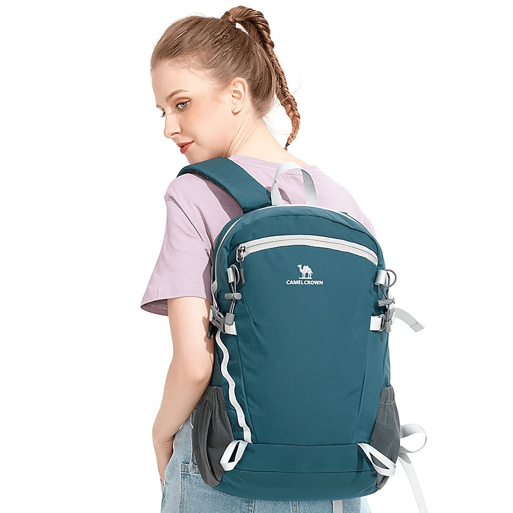 Woman wearing a lightweight waterproof hiking backpack, SF2301, ideal for travel and outdoor adventures. Features tactical storage and nylon construction.