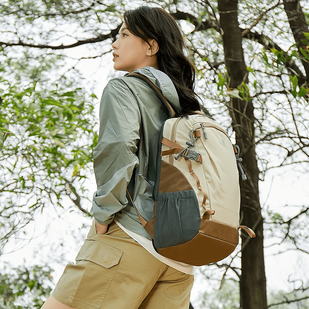 Woman wearing lightweight tactical backpack for hiking, camping, and sports. Ideal outdoor gear with waterproof nylon and padded straps.