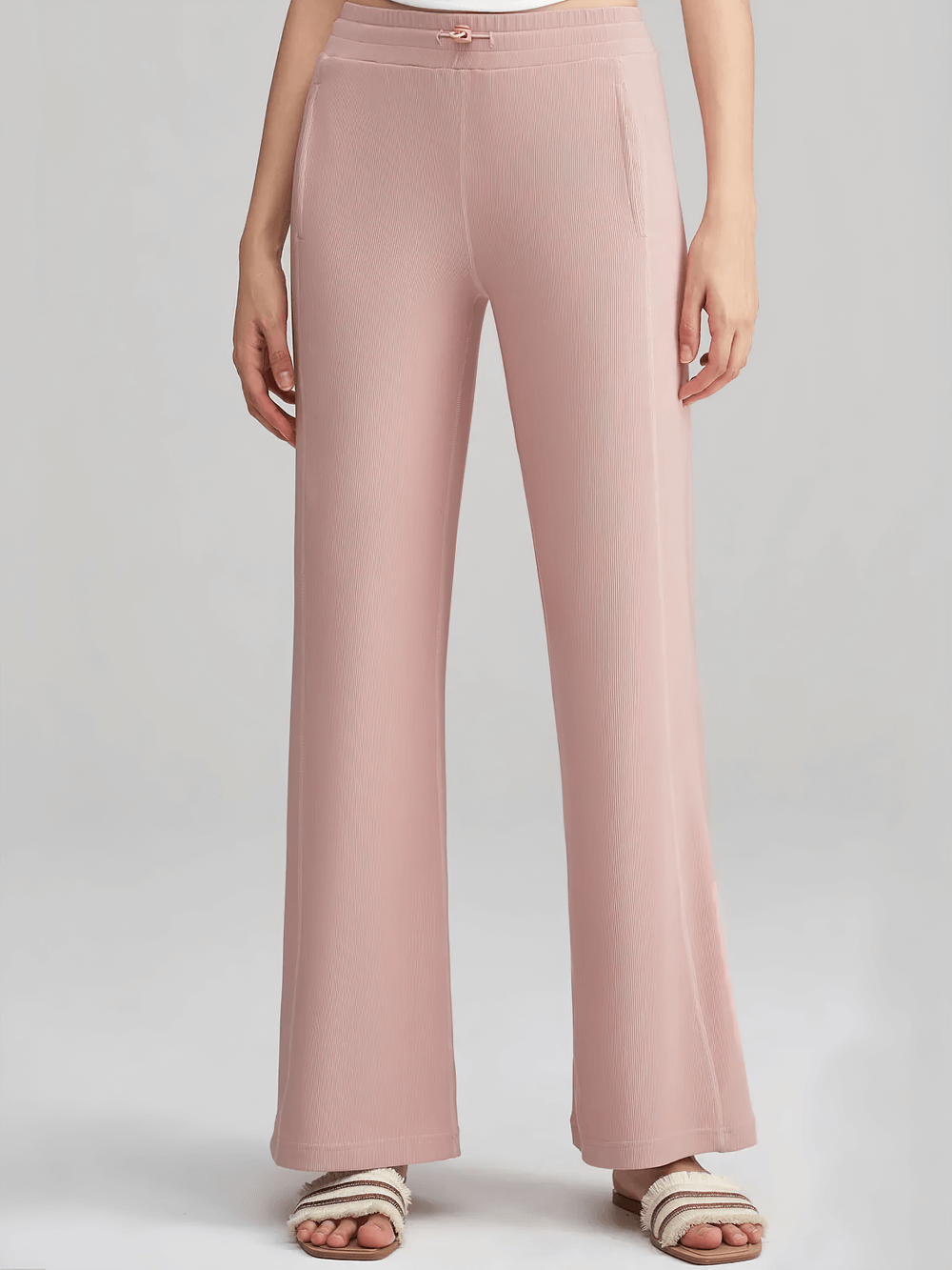 Lightweight wide-leg ribbed lounge pants for women in pink, featuring side pockets and a stretchy waistband.