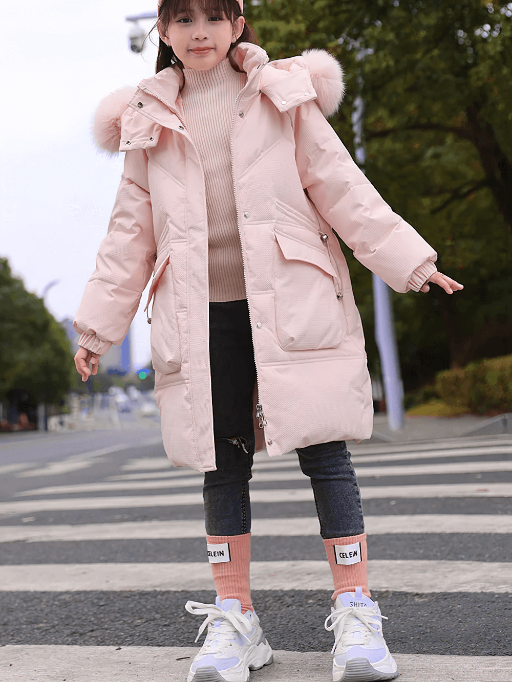 Girl wearing Long Down Coat with Hood and Faux Fur Trim - SF3525 standing outdoors on a street, showcasing winter fashion and big pockets.