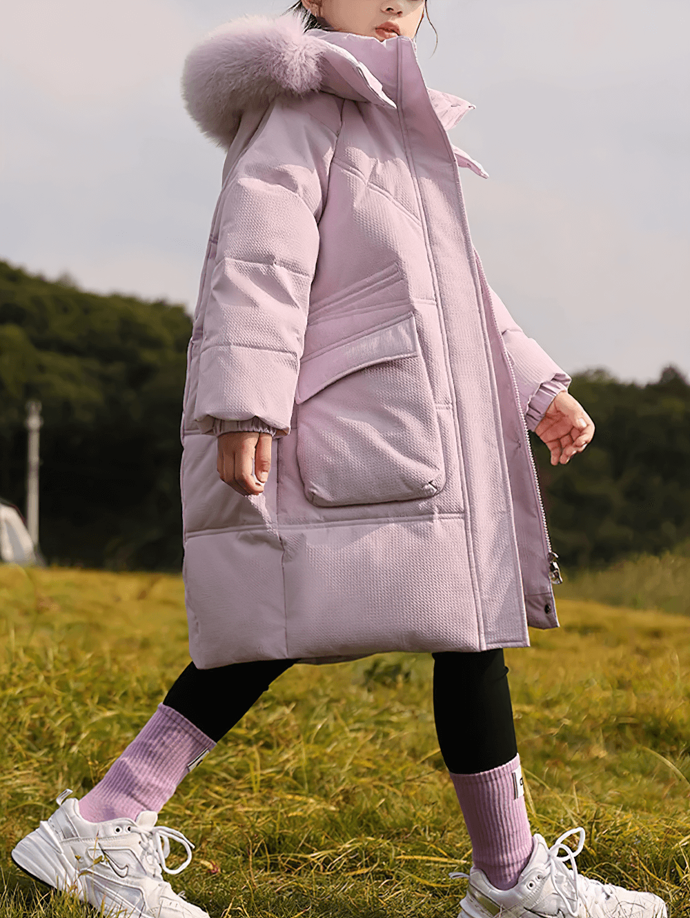 Girl wearing Long Down Coat with Hood and Faux Fur Trim - SF3525 in a grassy field, showcasing warmth and style with big pockets.