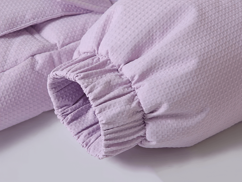 Sleeve detail of Long Down Coat with Hood and Faux Fur Trim - SF3525, showing textured fabric in light purple, perfect for winter warmth.