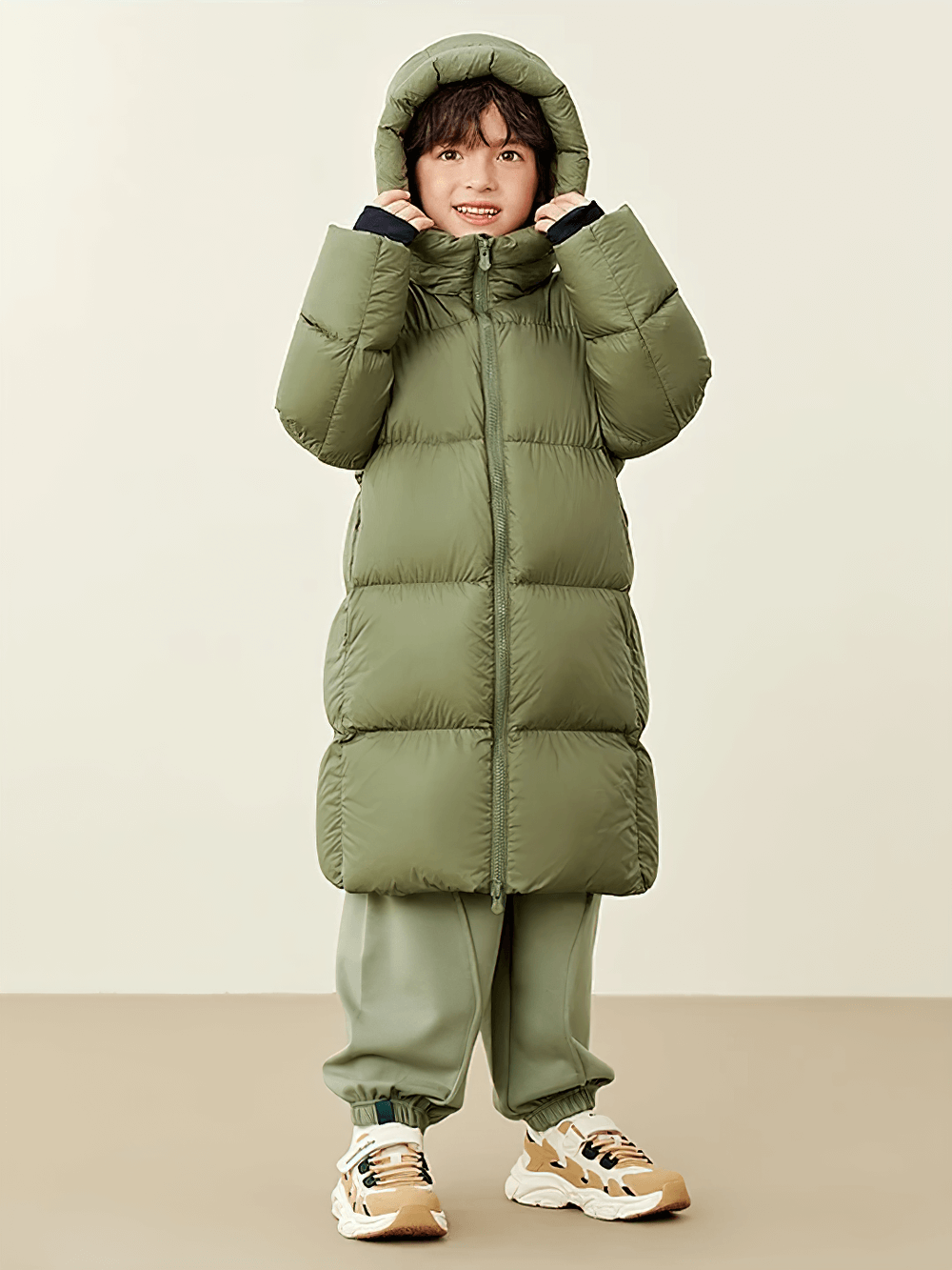 Child wearing Long Down Jacket with Windproof Hood Design - SF3512, keeping warm in a green waterproof winter puffer coat.