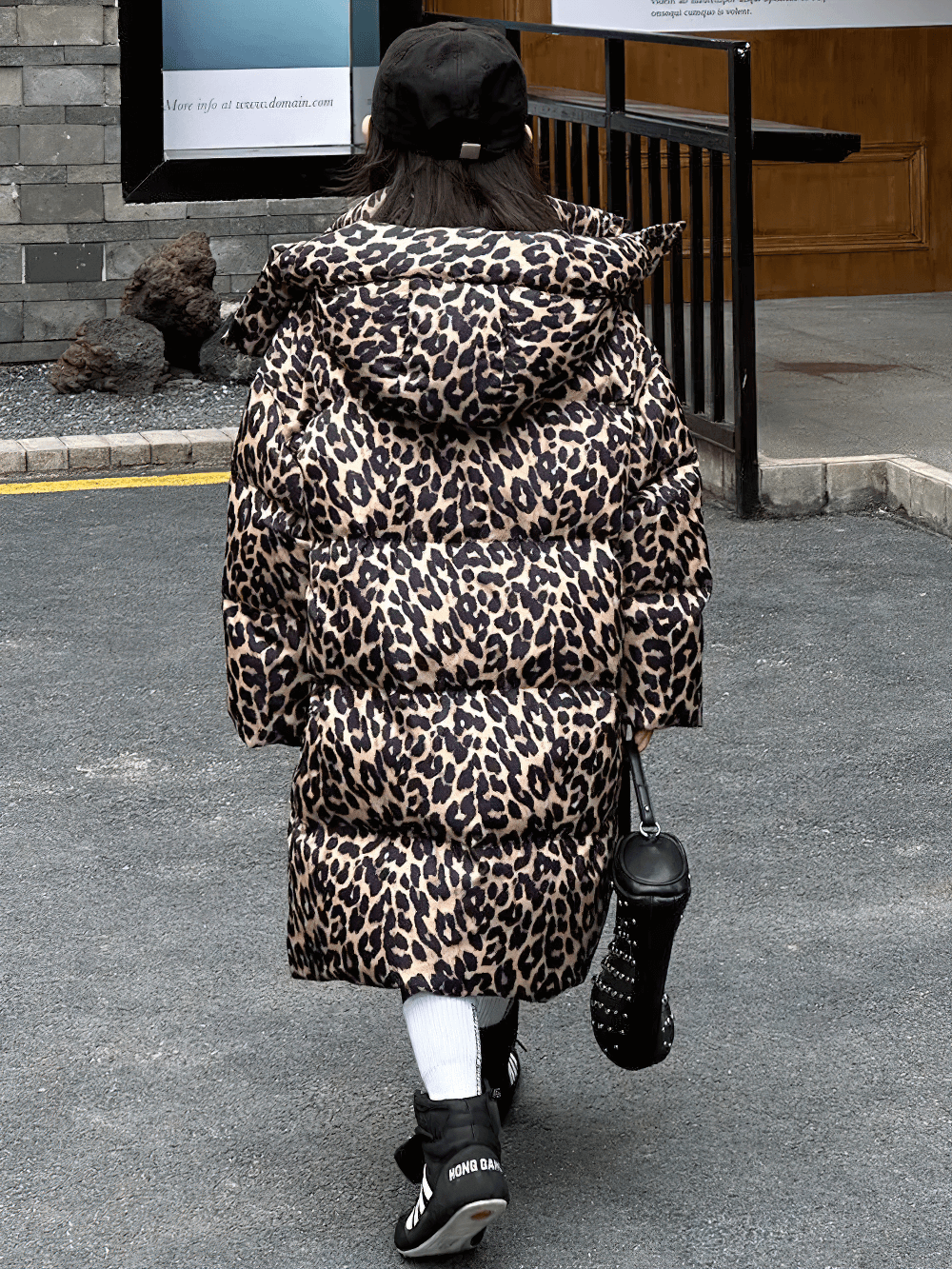 Young girl wearing a Long Leopard Print Hooded Puffer Coat - SF3527, showcasing a stylish winter look with animal print design.