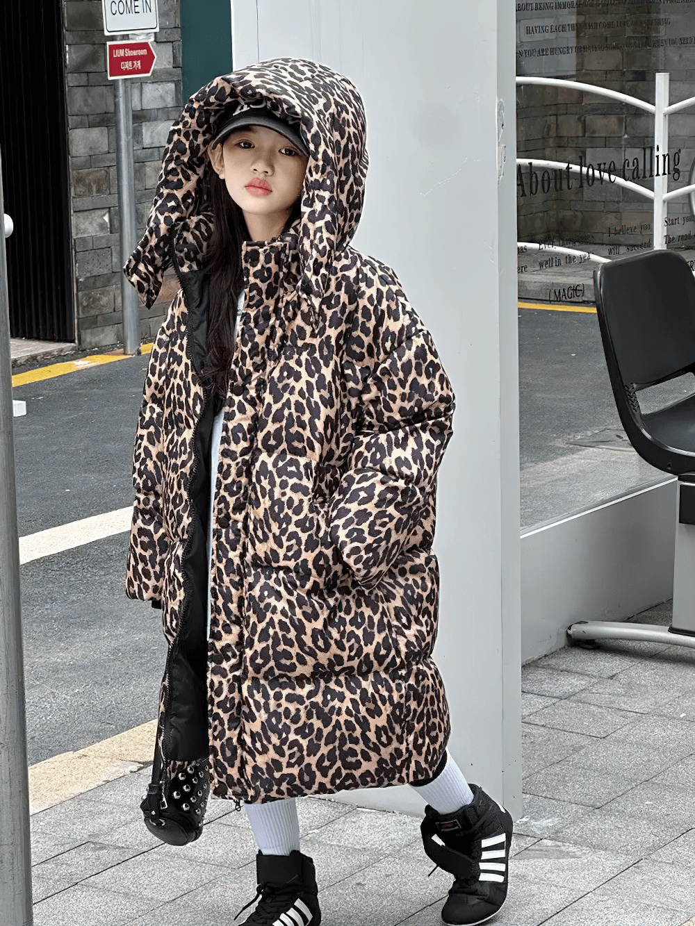 Girl wearing Long Leopard Print Hooded Puffer Coat - SF3527 with oversized hood and stylish animal print, perfect for winter adventures.
