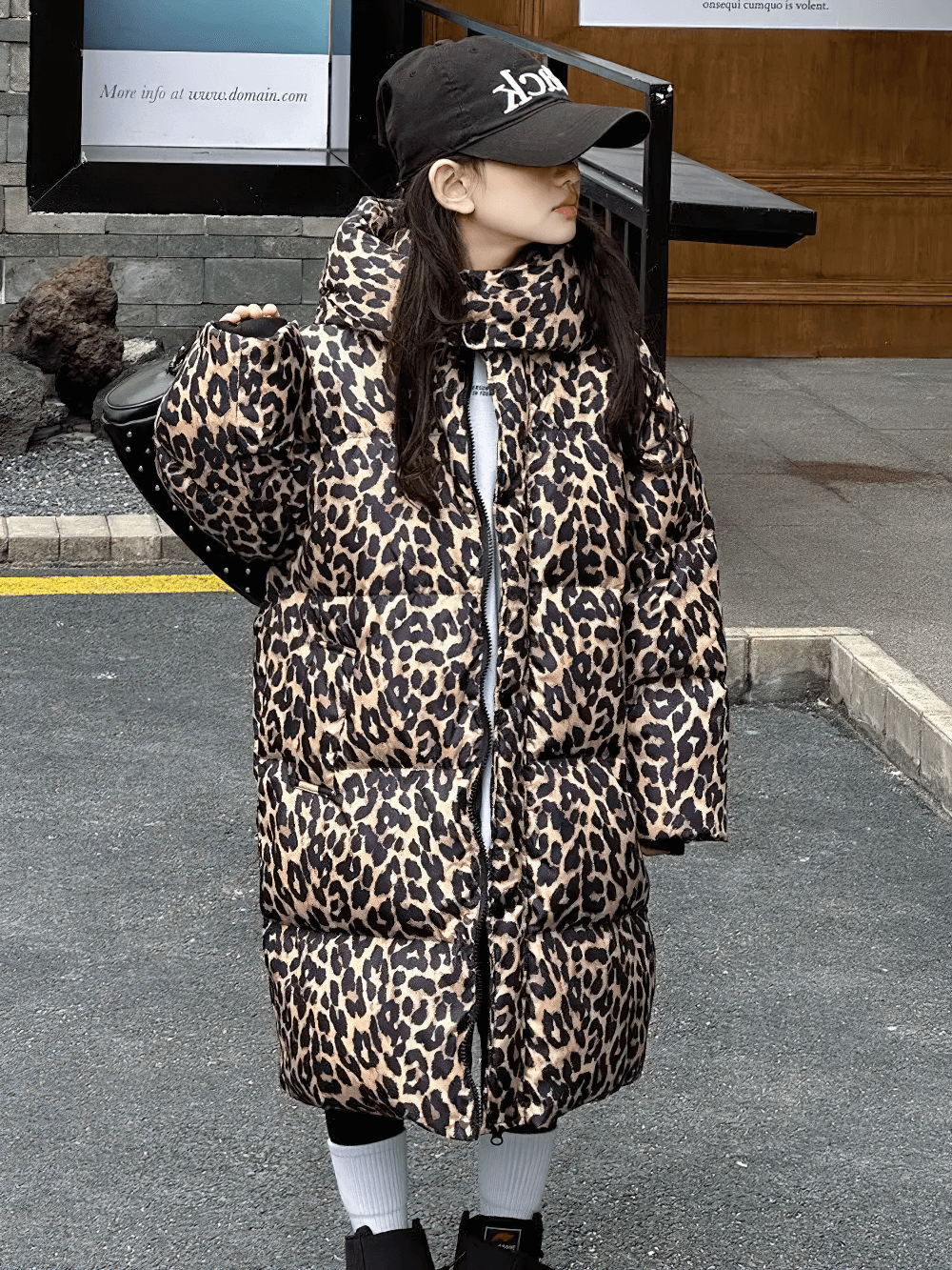 Girl wearing Long Leopard Print Hooded Puffer Coat - SF3527, showcasing stylish winter fashion with oversized hood and warm insulation.