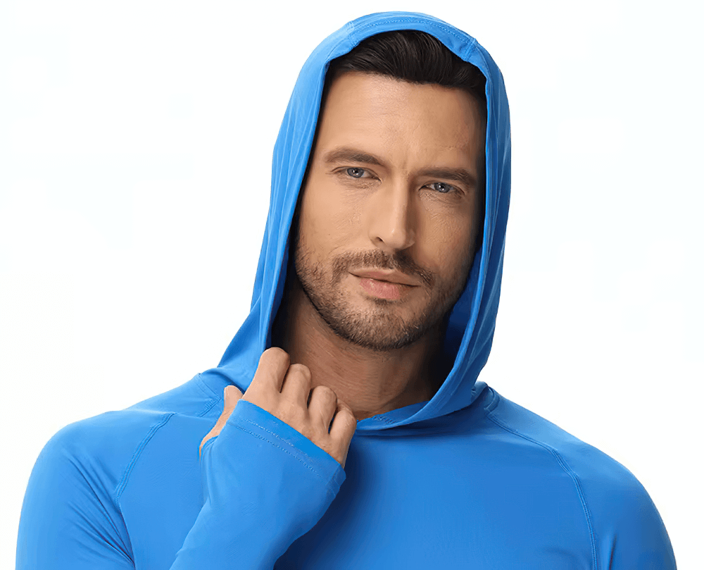 A man wearing a blue long sleeve hooded UV protection outdoor top, ideal for hiking and fishing, showcasing a comfortable and stylish fit.