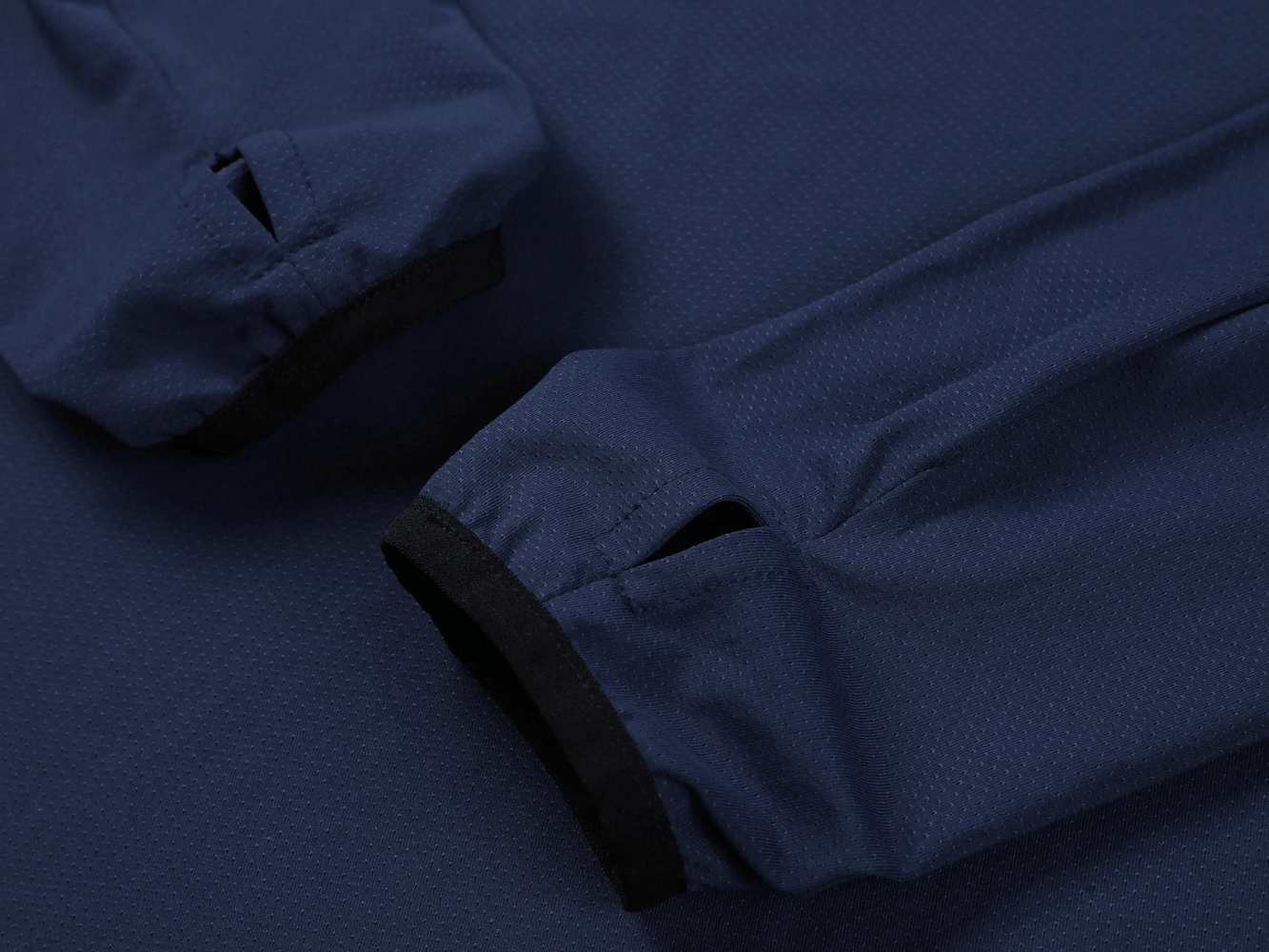 Close-up of the Long Sleeve Running Shirt with Sport Panels - SF4638 showing thumbhole cuffs in a navy color.