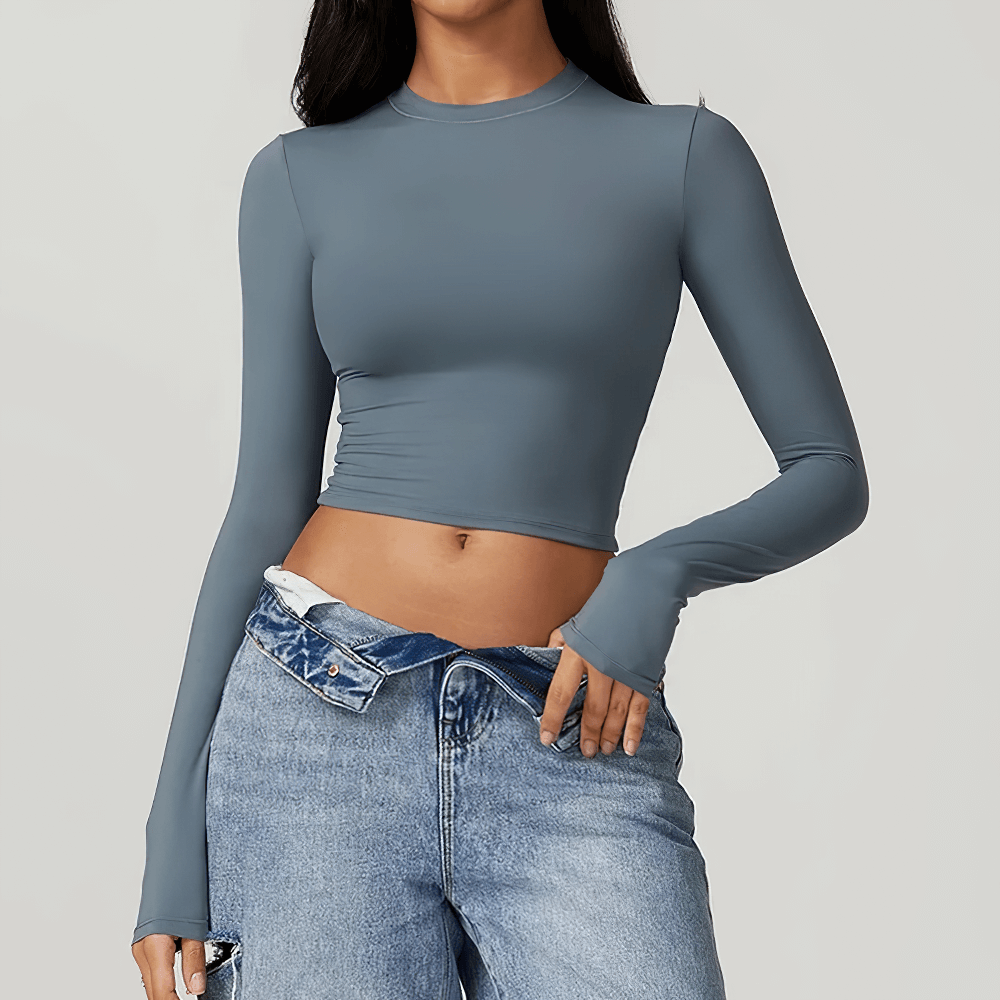 Blue long sleeve yoga crop top for women, perfect for gym and fitness, offering flexibility and durability in a sleek minimalist design.