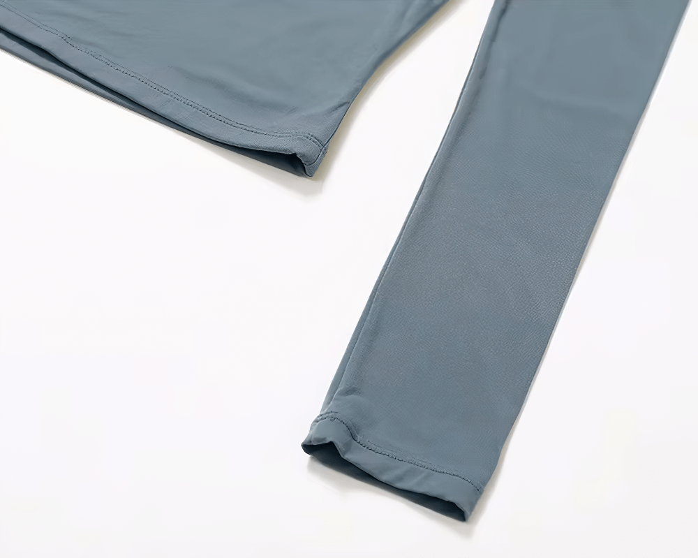 Long sleeve sports crop top for yoga, made of breathable nylon and spandex, showing sleek design and flexible material. Perfect for workouts.