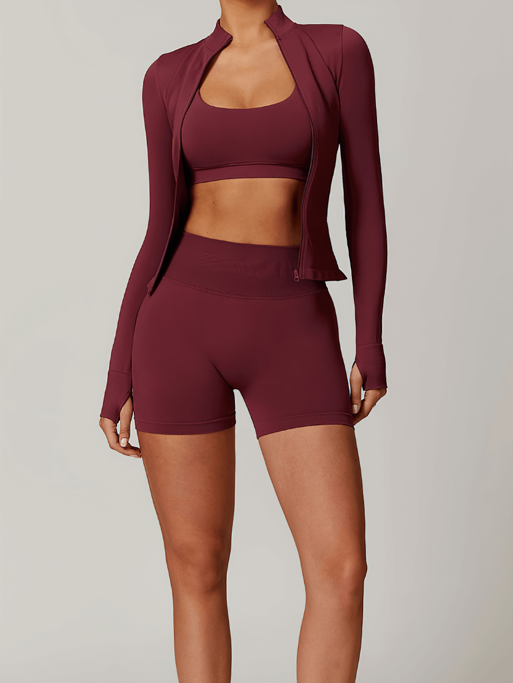 Woman wearing long-sleeve crop top and high-waisted shorts in burgundy, perfect activewear set for yoga and training - SF2388.