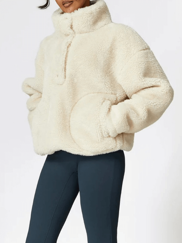 Woman wearing cream long sleeved lamb fleece jacket, perfect for outdoor yoga and exercise, combines style and comfort with anti-pilling fabric.